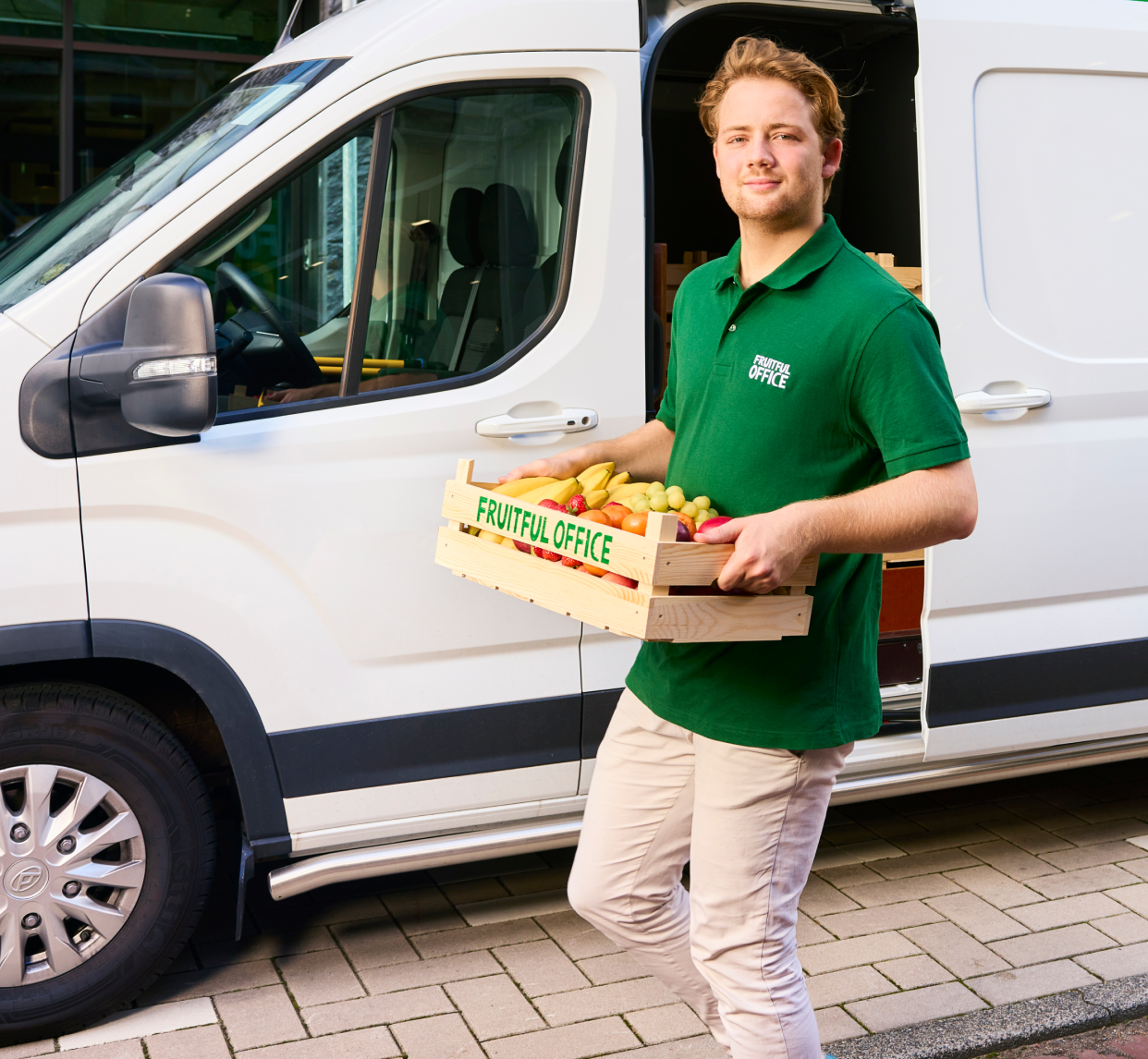 Livreur apporte une caisse de fruits au bureau